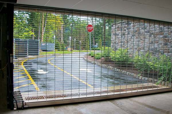 rolling-steel-security-grille-secures-parking-garage-entrance