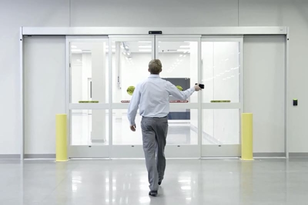 man-uses-mobile-bluetooth-enabled-access-control-to-open-automatic-door
